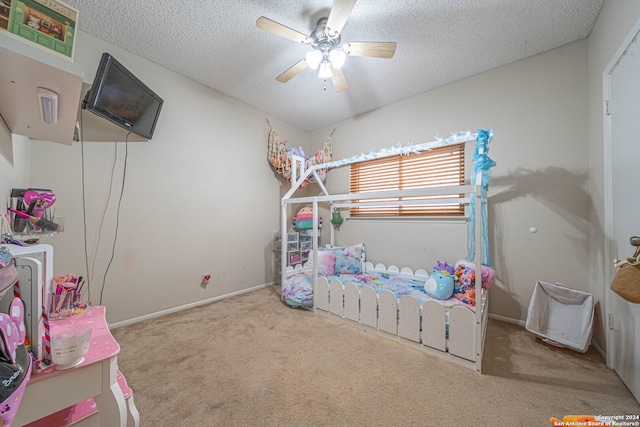 bedroom with a textured ceiling, light colored carpet, and ceiling fan