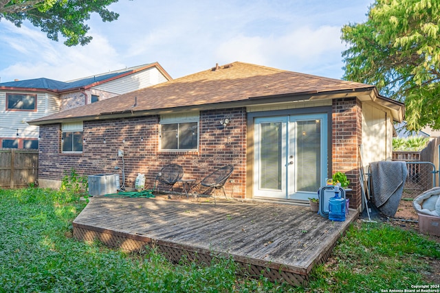 back of property featuring central AC unit and a deck