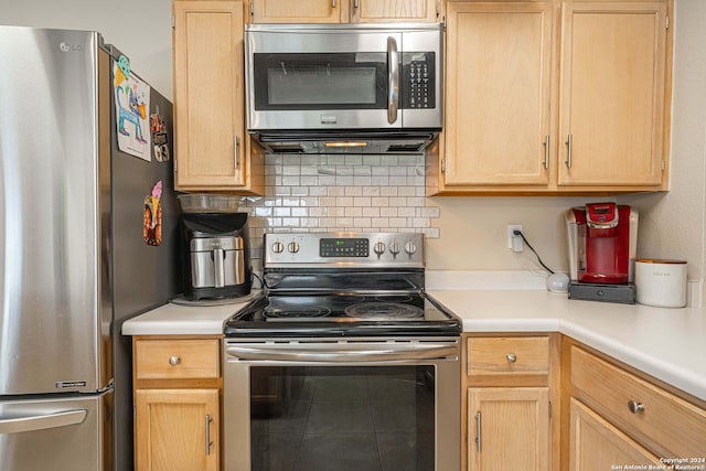 kitchen with backsplash, appliances with stainless steel finishes, and light brown cabinetry