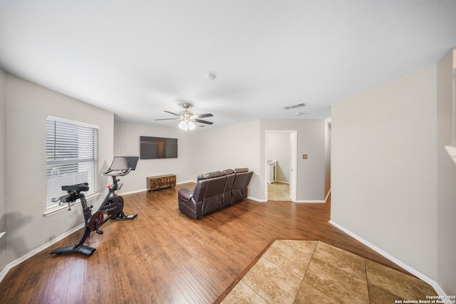 exercise area featuring wood-type flooring and ceiling fan