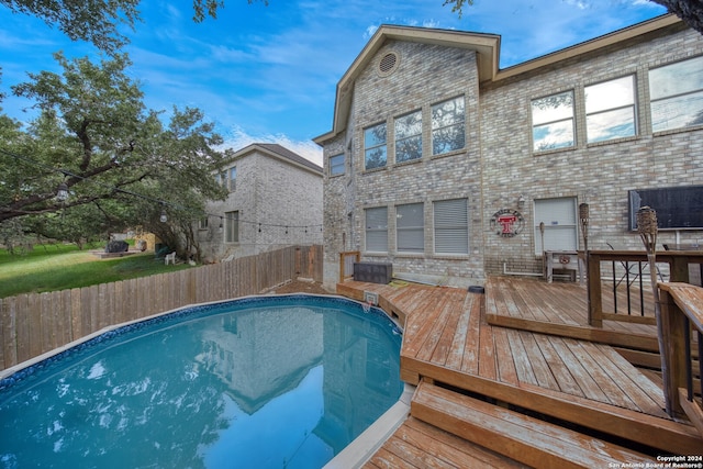 view of pool with a wooden deck