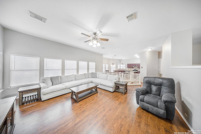 living room with wood-type flooring and ceiling fan