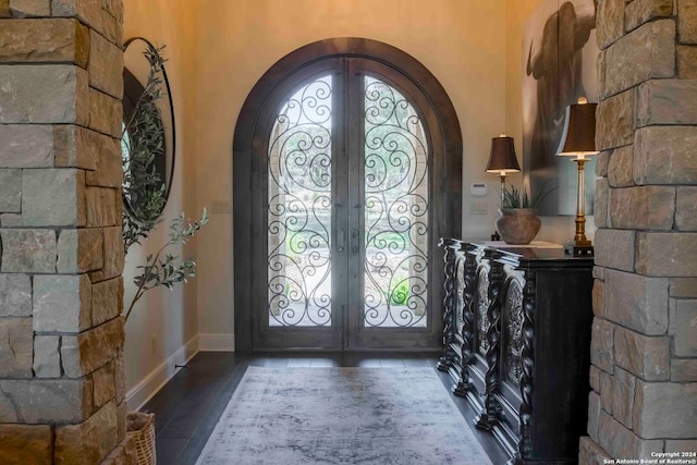 foyer with french doors and dark hardwood / wood-style flooring