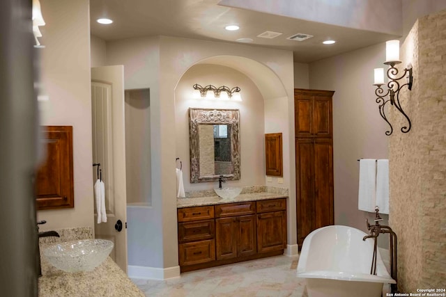 bathroom with a tub to relax in and vanity