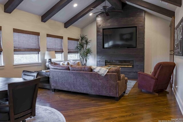 living room featuring vaulted ceiling, dark hardwood / wood-style floors, and a fireplace