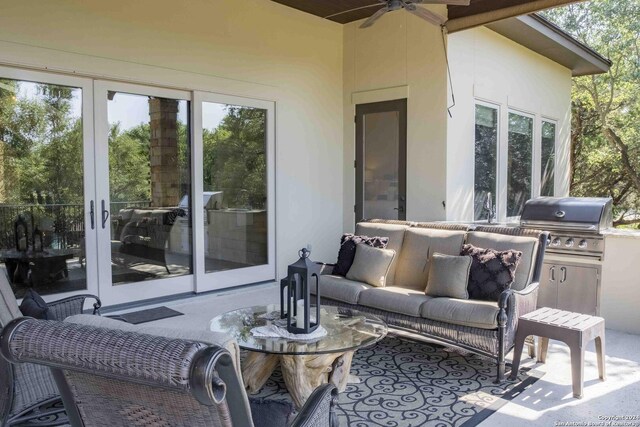 view of patio / terrace featuring an outdoor stone fireplace and ceiling fan