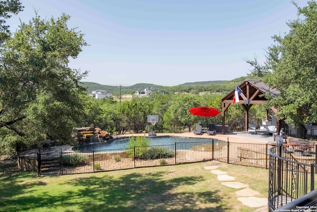 view of pool featuring a lawn and a patio