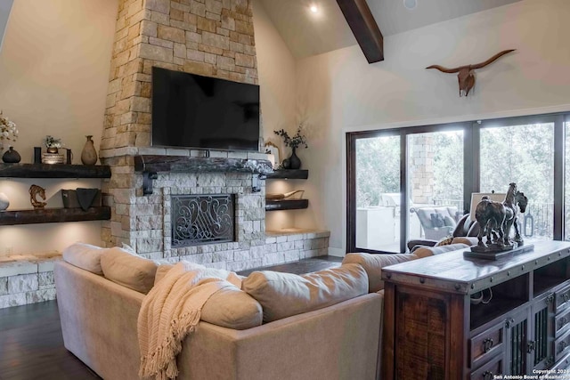 living room with dark hardwood / wood-style flooring, plenty of natural light, vaulted ceiling with beams, and a stone fireplace