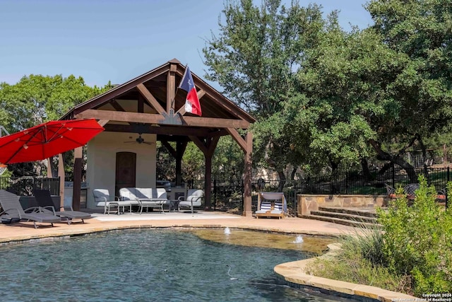 view of swimming pool with a patio area, ceiling fan, and a gazebo