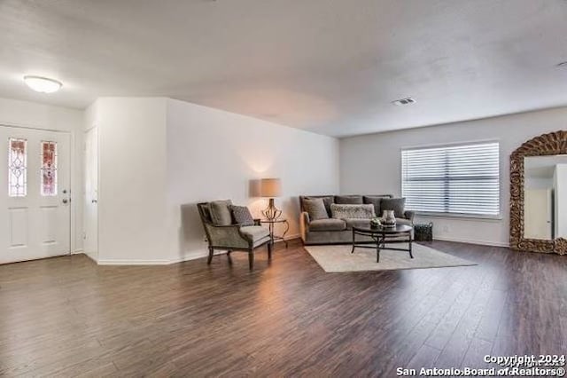 living room with dark hardwood / wood-style flooring