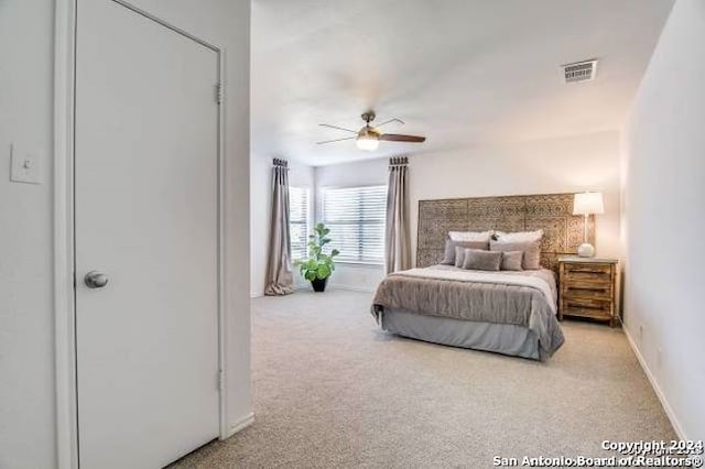 bedroom featuring ceiling fan and light carpet