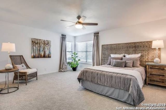 bedroom featuring light carpet and ceiling fan