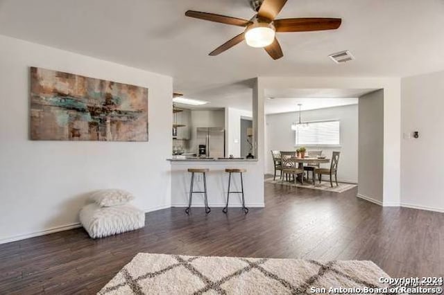 living room with ceiling fan and dark hardwood / wood-style floors