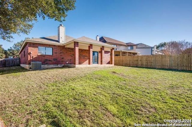 exterior space featuring a front lawn and central AC