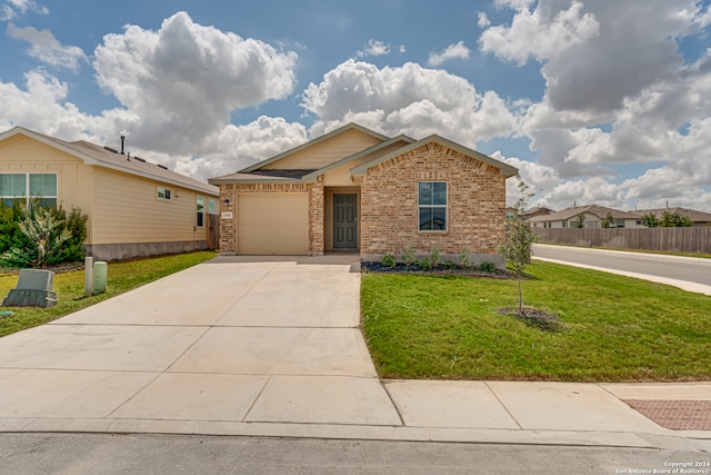 view of front of home featuring a garage and a front lawn