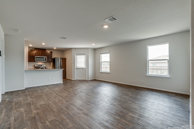 unfurnished living room featuring hardwood / wood-style flooring