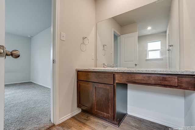 bathroom with vanity and wood-type flooring