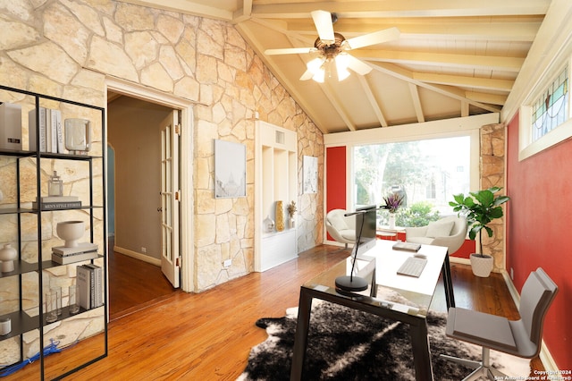 sunroom with ceiling fan and vaulted ceiling with beams