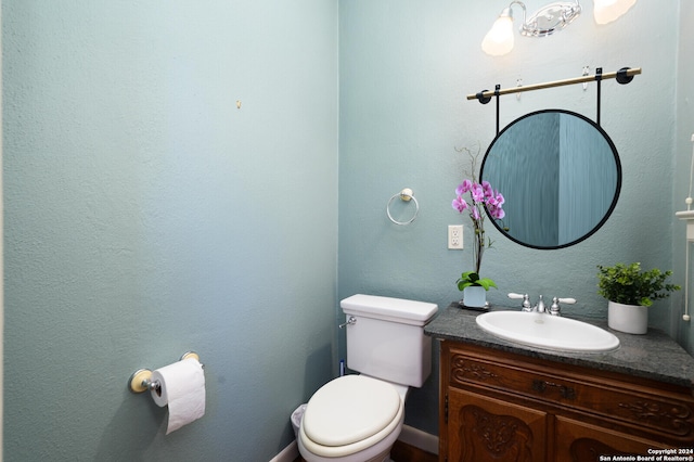 bathroom featuring toilet and vanity