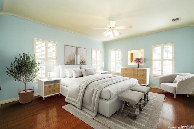 bedroom with multiple windows, dark wood-type flooring, and ceiling fan