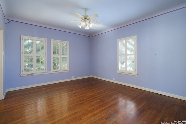 unfurnished room with ceiling fan and dark hardwood / wood-style flooring