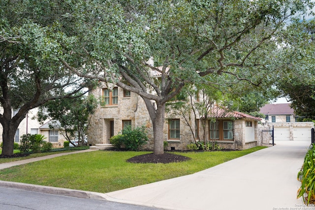 view of front facade with a garage and a front lawn