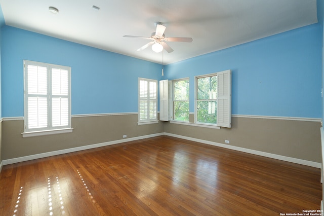 unfurnished room with ceiling fan and dark hardwood / wood-style floors