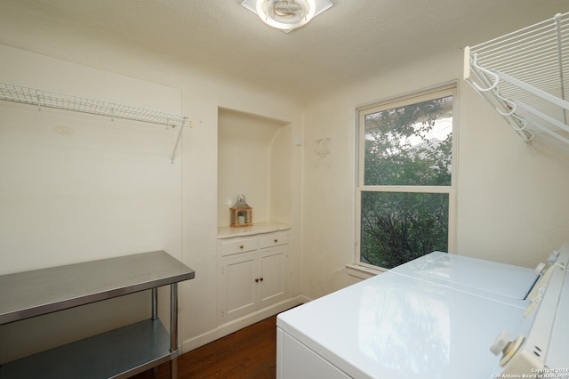 clothes washing area featuring washer and dryer and dark hardwood / wood-style flooring