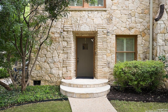 entrance to property with stone siding