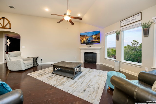 living room with ceiling fan, lofted ceiling, and dark wood-type flooring