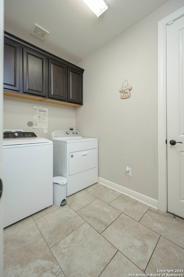 laundry room with cabinets and washer and dryer