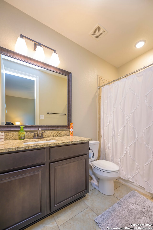 bathroom featuring tile patterned flooring, vanity, toilet, and a shower with shower curtain