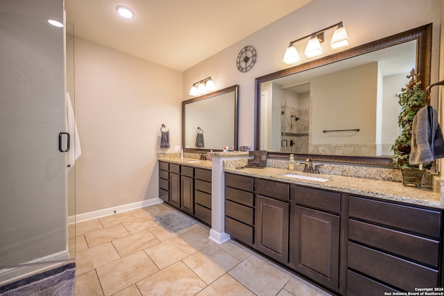 bathroom featuring tile patterned flooring, vanity, and a shower with door