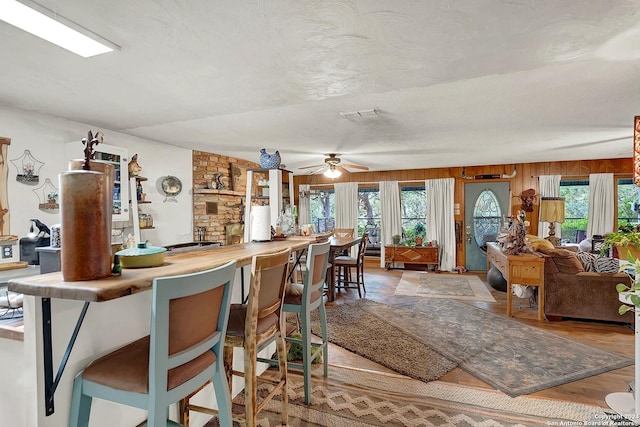 interior space featuring visible vents, plenty of natural light, a textured ceiling, and light wood finished floors