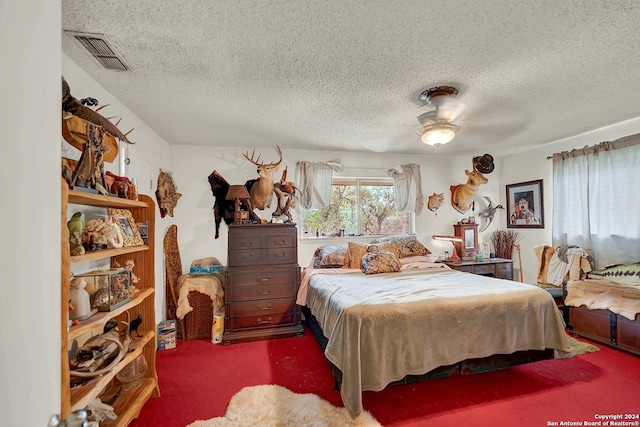 carpeted bedroom with visible vents and a textured ceiling