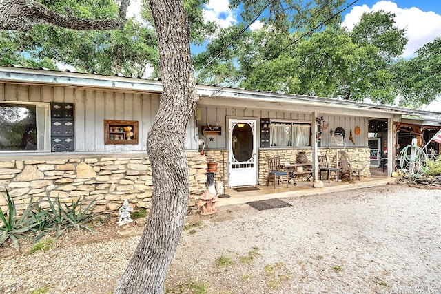 view of front of property featuring stone siding and board and batten siding