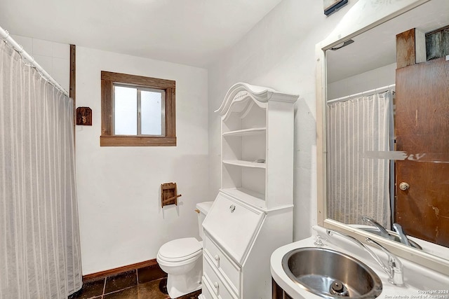 bathroom with toilet, baseboards, and vanity