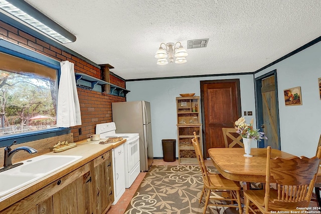 kitchen with white range with electric stovetop, light countertops, visible vents, a sink, and a textured ceiling