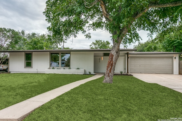 ranch-style home featuring a front yard and a garage