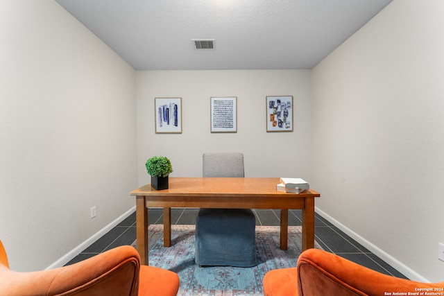 office space with dark tile patterned floors and a textured ceiling