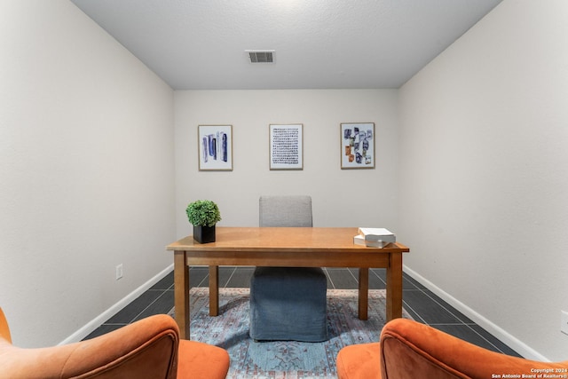 office with tile patterned flooring, visible vents, and baseboards