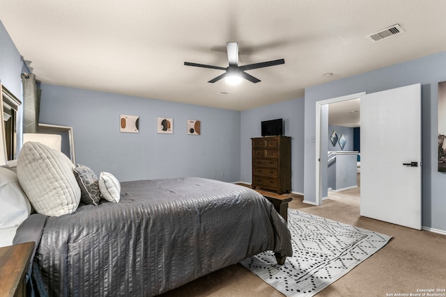 carpeted bedroom featuring a textured ceiling and ceiling fan