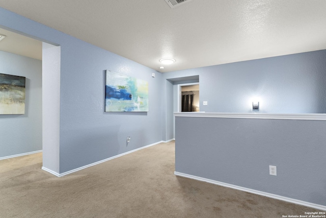 carpeted spare room with baseboards