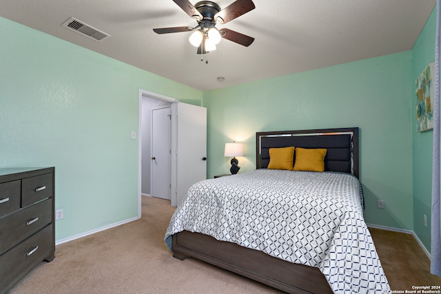 bedroom featuring light colored carpet and ceiling fan