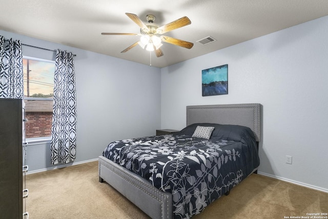 bedroom featuring visible vents, carpet, baseboards, and ceiling fan