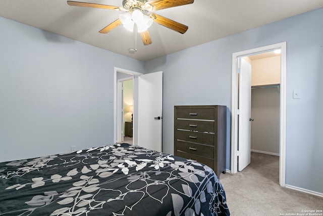 carpeted bedroom featuring a closet, ceiling fan, a spacious closet, and a textured ceiling