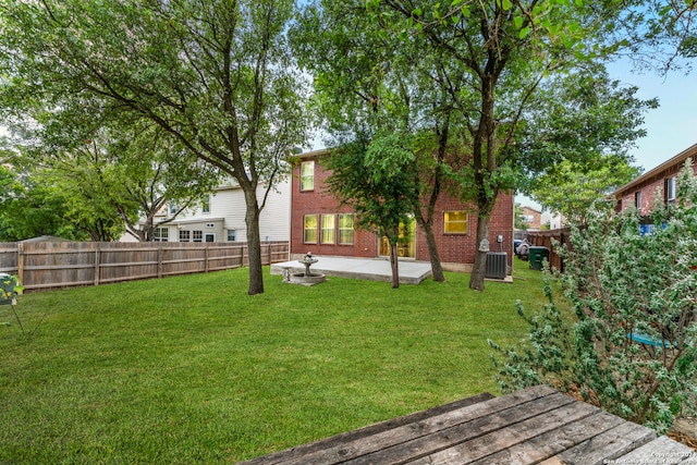 view of yard featuring cooling unit and a patio area