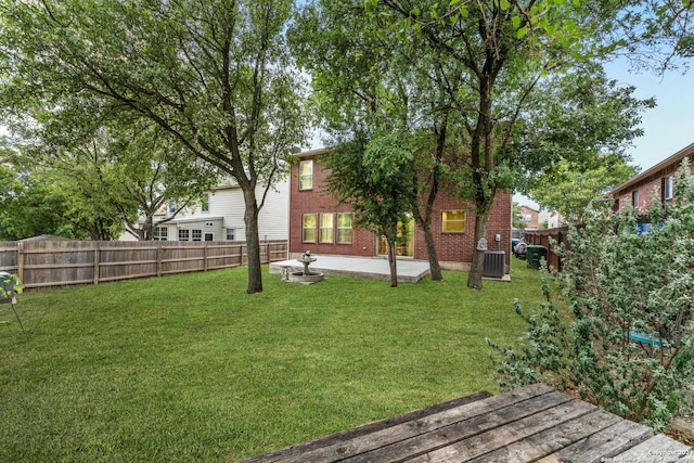 view of yard featuring a patio, central AC, and a fenced backyard