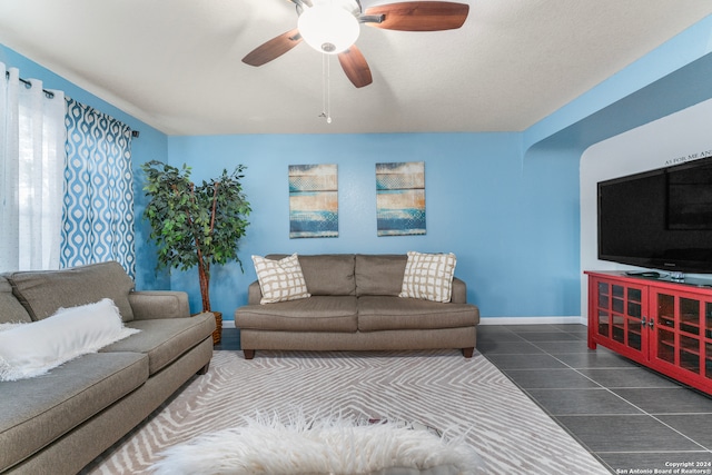 living room with ceiling fan and tile patterned floors