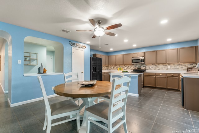 dining space with ceiling fan, a textured ceiling, and sink